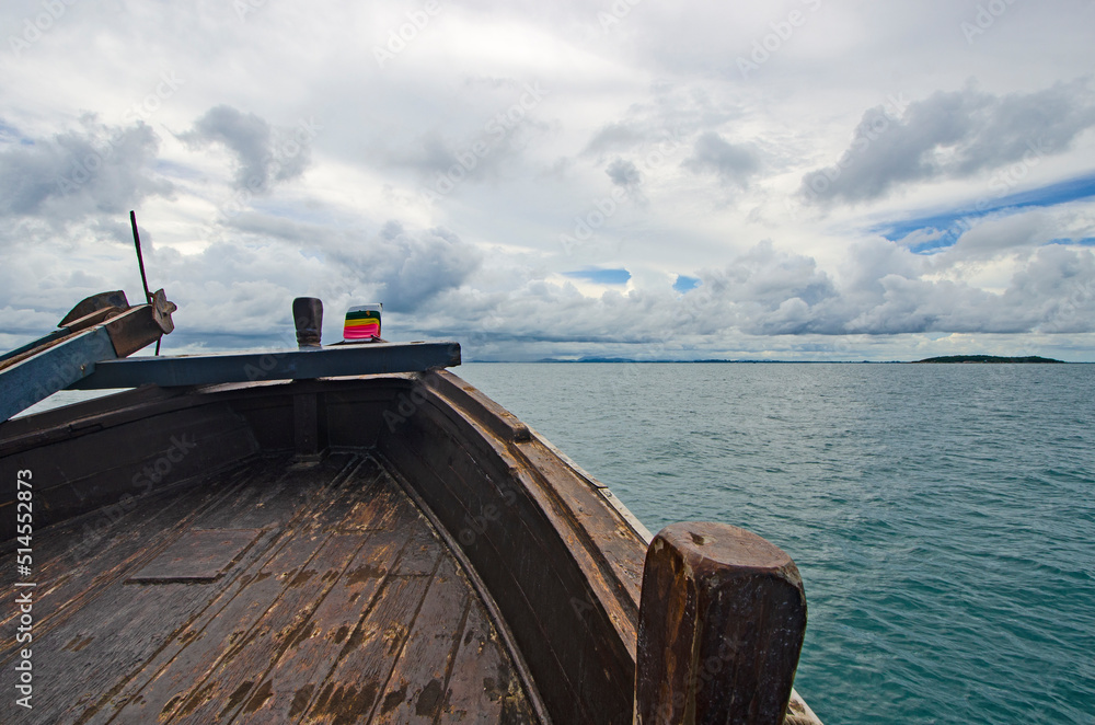 Wooden prow in the sea and cloudy sky background