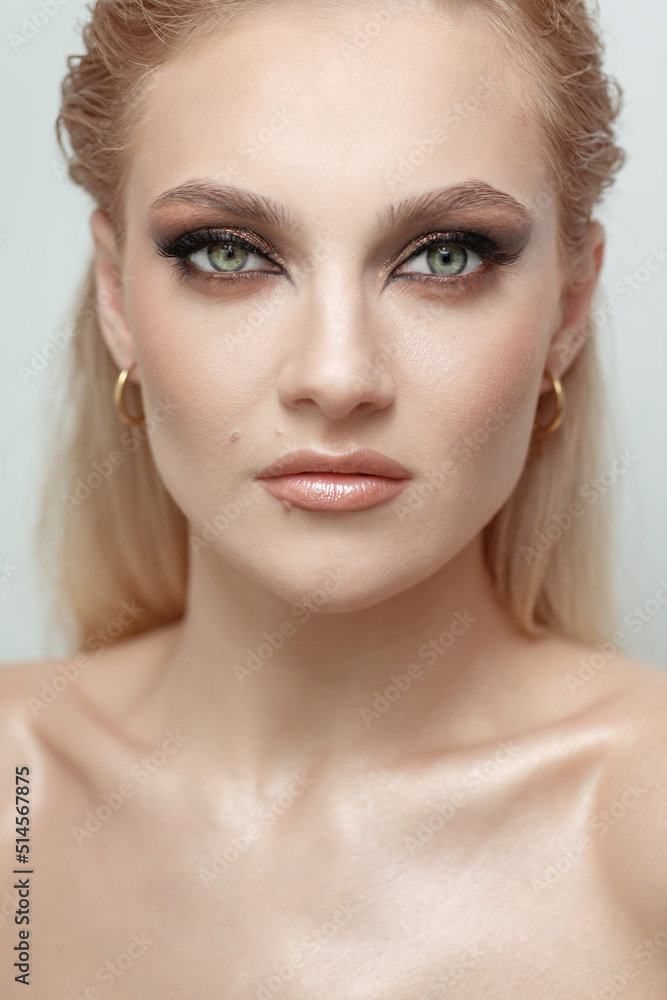Beauty, fashion, style and makeup concept. Close up beautiful blonde girl with green eyes studio portrait. Sexy looking woman with fancy evening makeup looking to camera. Eyes is in camera focus Beauty, fashion, style and makeup concept. Close up beautiful blonde girl with green eyes studio portrait. Sexy looking woman with fancy evening makeup looking to camera. Eyes is in camera focus