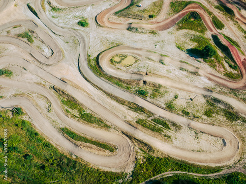 Motocross track in the middle of a green countryside. Aerial view. 