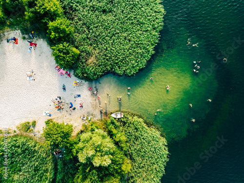 Summer time at the lake. Rest on the beach. Aerial view of small hidden beach.
