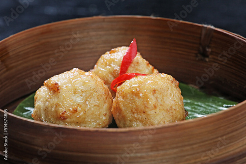 Fried meatball dimsum, served in a round bamboo container. Typical traditional Chinese dimsum serving container