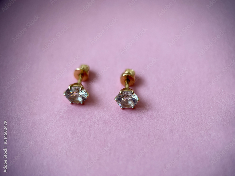 Gold stud earrings with cubic zirconia close-up Gold stud earrings with cubic zirconia close-up