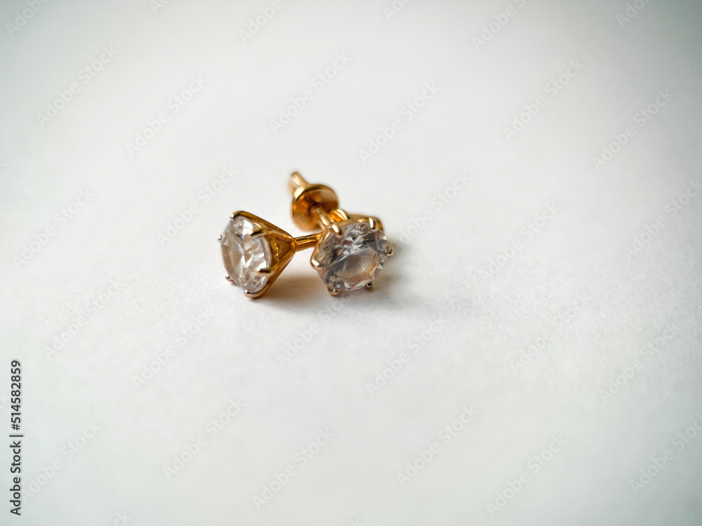 Gold stud earrings with cubic zirconia close-up Gold stud earrings with cubic zirconia close-up