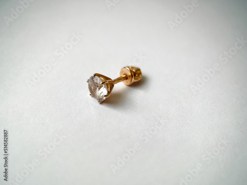 Gold stud earrings with cubic zirconia close-up photo