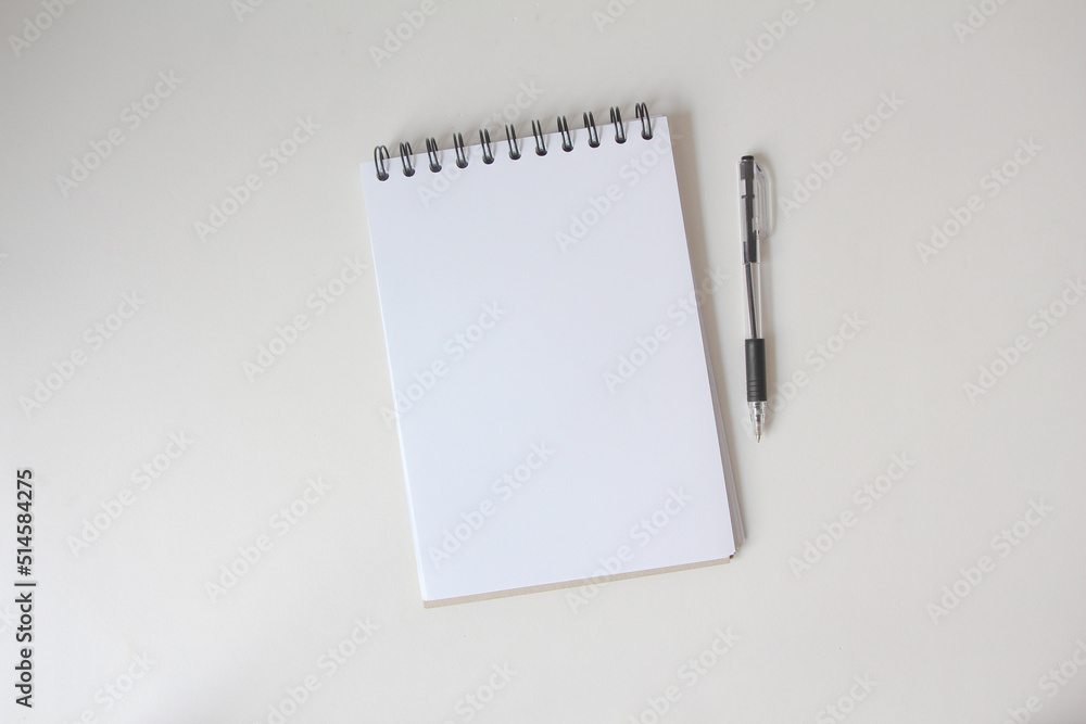 blank notebook at the white desk. Flat lay top view. blank notebook at the white desk. Flat lay top view.