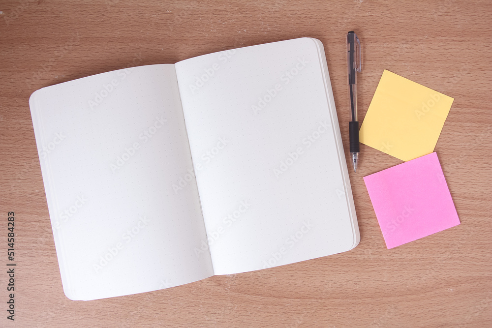 empty notebook at the white desk. Flat lay top view. empty notebook at the white desk. Flat lay top view.