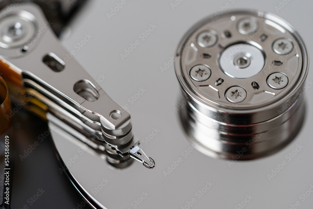 Opened hard disk after disassembly during repair or service, macro shot. Computer HDD inside, selective soft focus. Laptop or PC storage memory Opened hard disk after disassembly during repair or service, macro shot. Computer HDD inside, selective soft focus. Laptop or PC storage memory