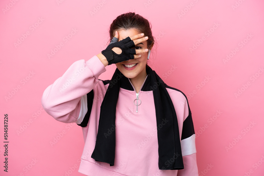 Young sport Brazilian woman isolated on pink background covering eyes by hands and smiling Young sport Brazilian woman isolated on pink background covering eyes by hands and smiling