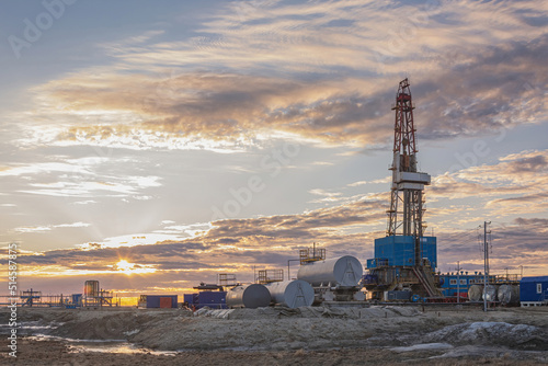 General view of a drilling rig for drilling wells at an oil and gas field in the Arctic region. Drilling equipment and technical infrastructure. Beautiful sky
