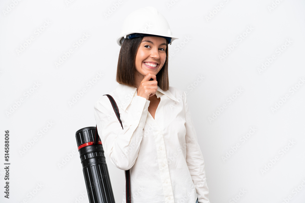 Young architect woman with helmet and holding blueprints isolated on white background happy and smiling