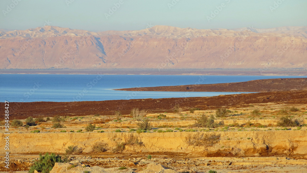 panorama of the Dead Sea of azure color with the mountains in the background and the desert in the foreground