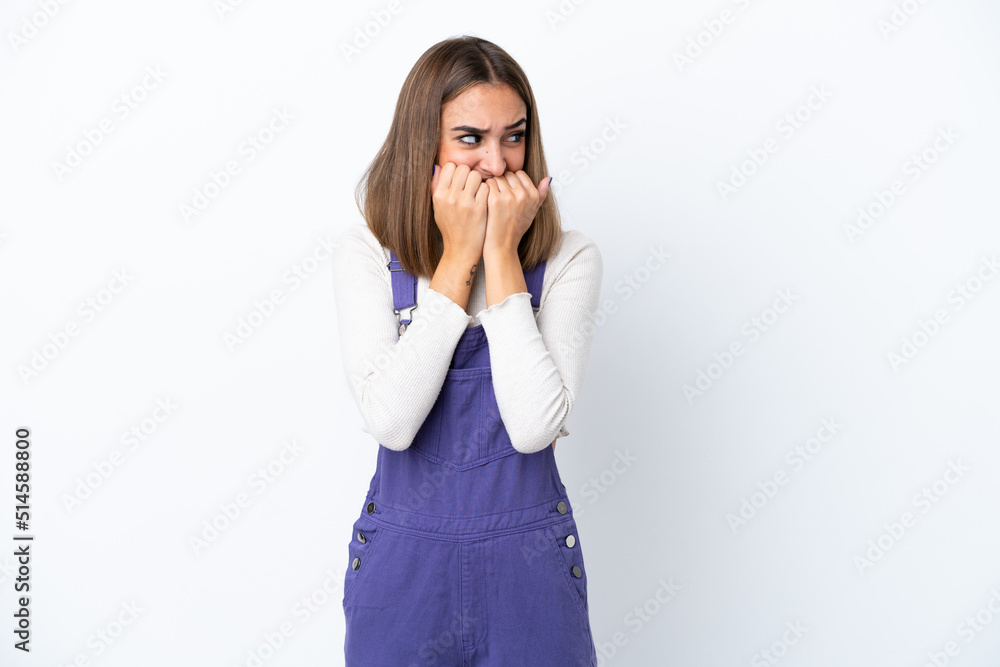 Young caucasian woman isolated on white background nervous and scared putting hands to mouth Young caucasian woman isolated on white background nervous and scared putting hands to mouth