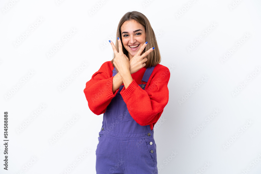Young caucasian woman isolated on white background smiling and showing victory sign