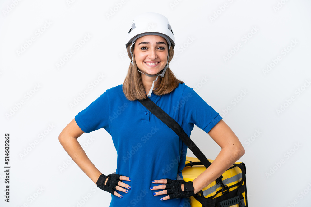 Young caucasian woman with thermal backpack isolated on white background posing with arms at hip and smiling Young caucasian woman with thermal backpack isolated on white background posing with arms at hip and smiling