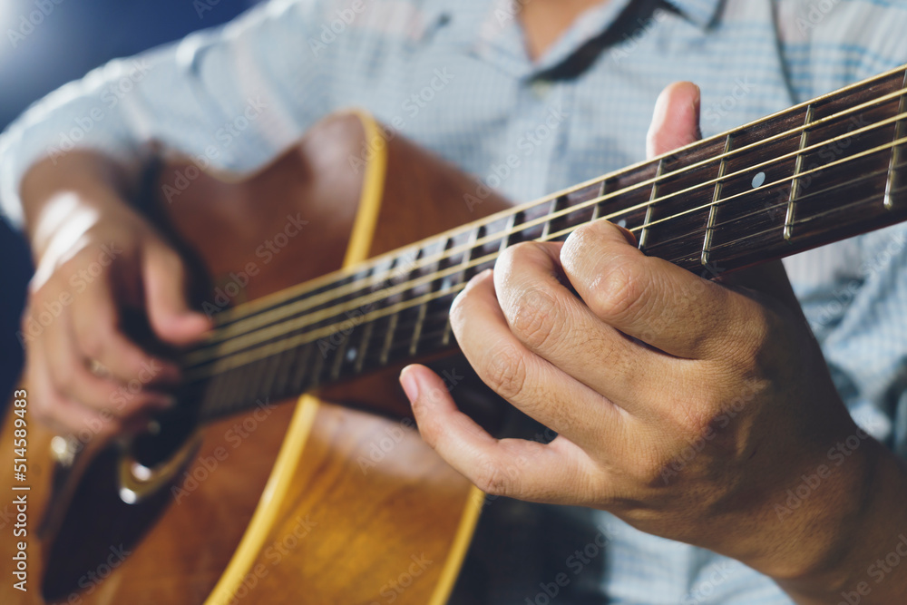 Fototapeta premium Closeup of hand playing acoustic guitar