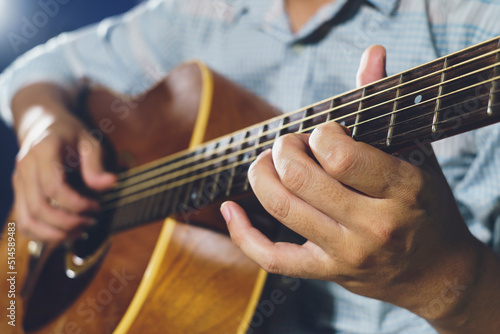 Closeup of hand playing  acoustic guitar