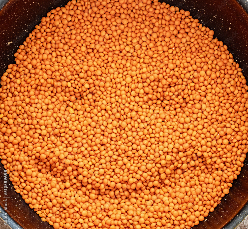 Red lentils as food texture with smiley face. Helthy grain reach with