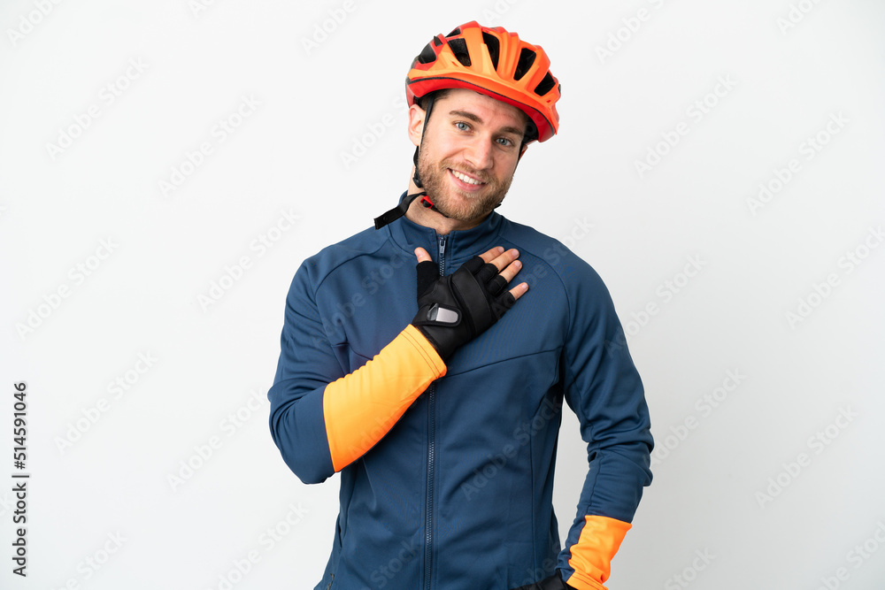 Young cyclist man isolated on white background looking up while smiling Young cyclist man isolated on white background looking up while smiling