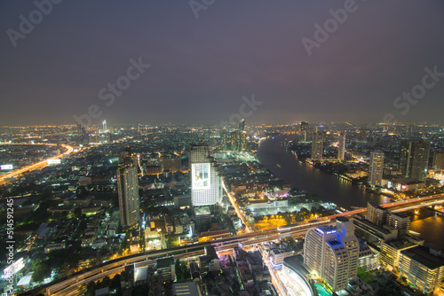 Night traffic road light with city building aerial view