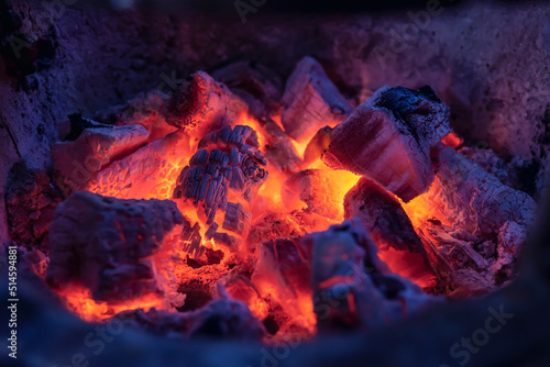 Close-up photo of hot coals in a clay oven
