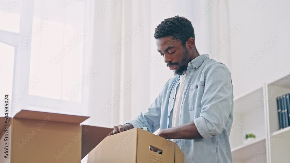 Sad interracial couple packing things, moving out of house, financial problems Sad interracial couple packing things, moving out of house, financial problems