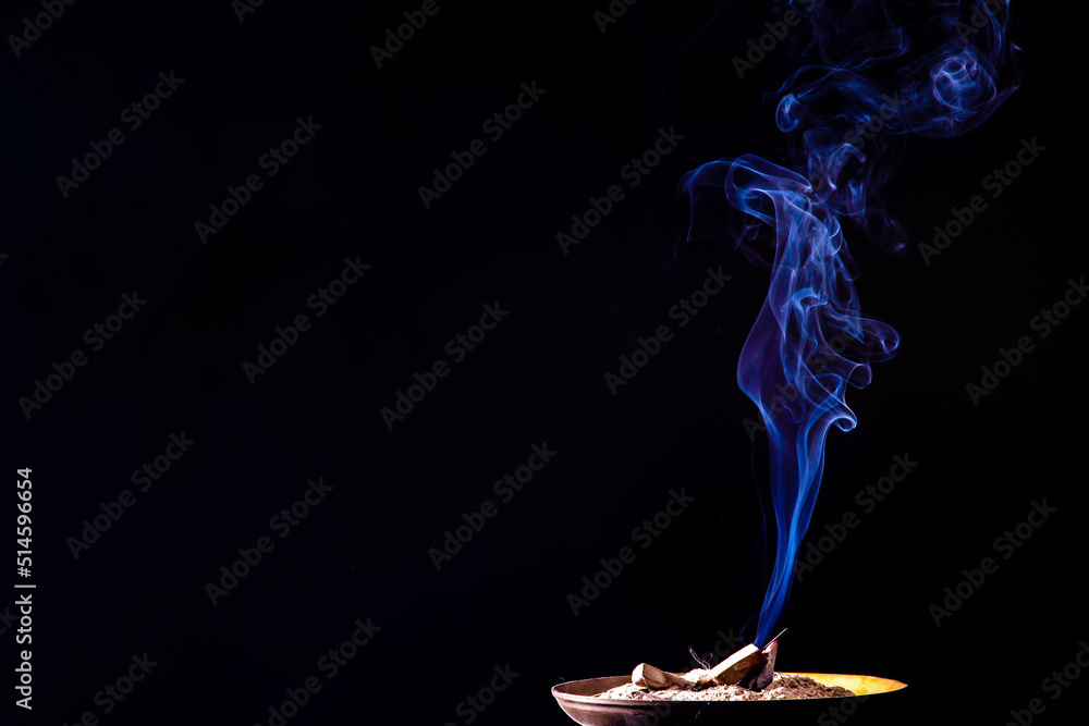 Closeup of smoke from burning incense stick on black background Closeup of smoke from burning incense stick on black background