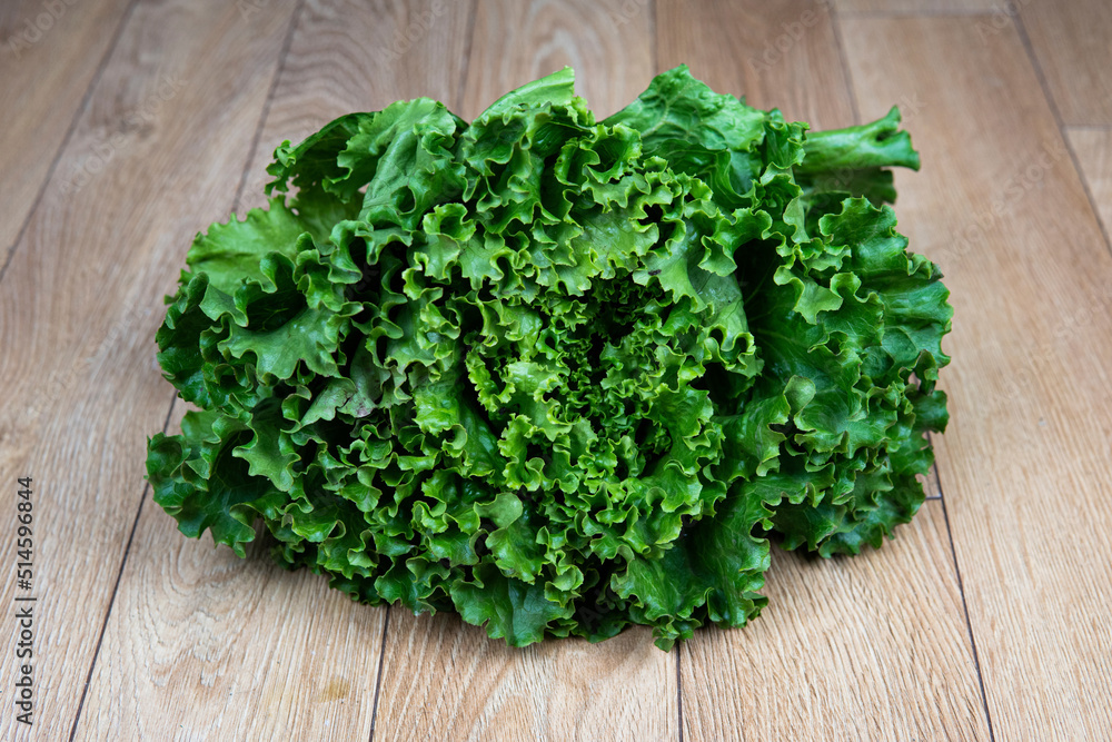 green lettuce salad on a wooden board green lettuce salad on a wooden board