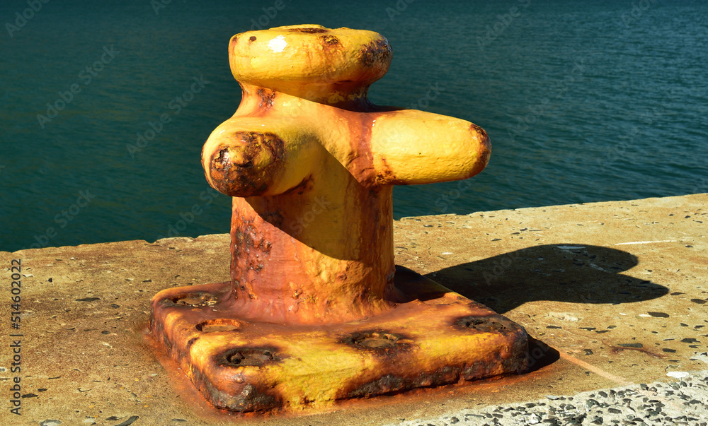 A solid mooring post slowly rusting in the sea atmosphere A solid mooring post slowly rusting in the sea atmosphere
