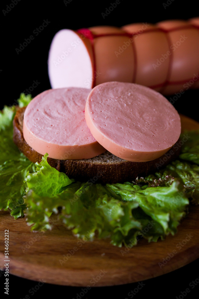 sausage on a plate. sausage and salad. meat and sausage. Cooked sausage. Pieces of sausage on black bread. sausage on a plate. sausage and salad. meat and sausage. Cooked sausage. Pieces of sausage on black bread.
