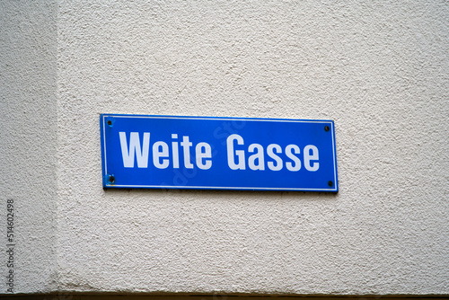 Road sign of alley with text Weite Gasse (German, translation is wide alley) at the old town of Zürich on a cloudy summer day. Photo taken June 28th, 2022, Zurich, Switzerland.