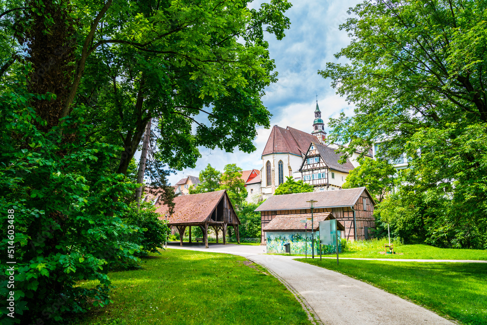 Germany, Waiblingen historical old town church steeple building behind timbered houses in summer on sunny day between green nature landscape in urban park
