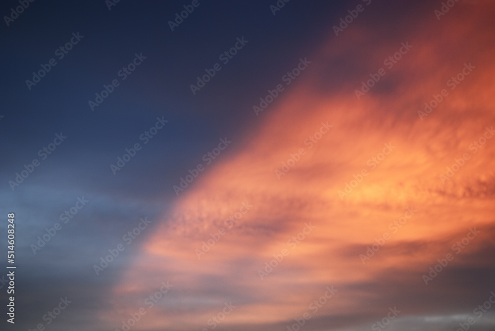 Orange in blue evening light sky before sunset. Calm atmosphere in autumn. Thin clouds in natural sky with colorful pastel tone colors for background. 