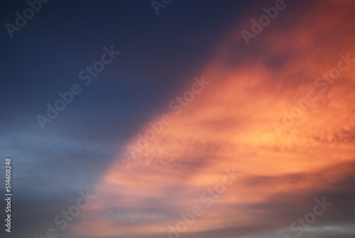 Orange in blue evening light sky before sunset. Calm atmosphere in autumn. Thin clouds in natural sky with colorful pastel tone colors for background. 