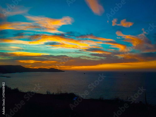 Scenic view of a calm coast during sunset with moutains and jetty in the background, Oran Algeria © Iceman_31