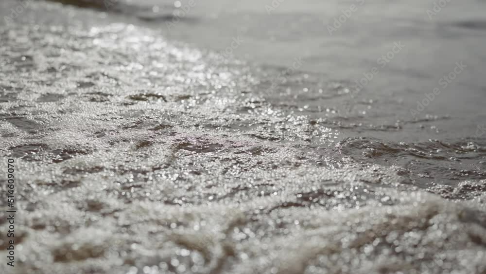 Slow motion closeup shot of waves rolling on a beach on Baltic Sea Slow motion closeup shot of waves rolling on a beach on Baltic Sea