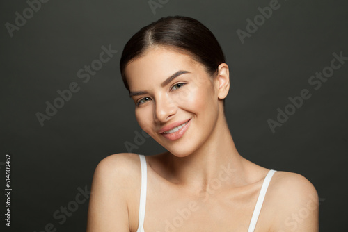 Young brunette model woman with clean skin, beautiful face close up