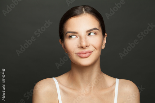 Young spa model woman with healthy clean skin looking aside. Female face closeup