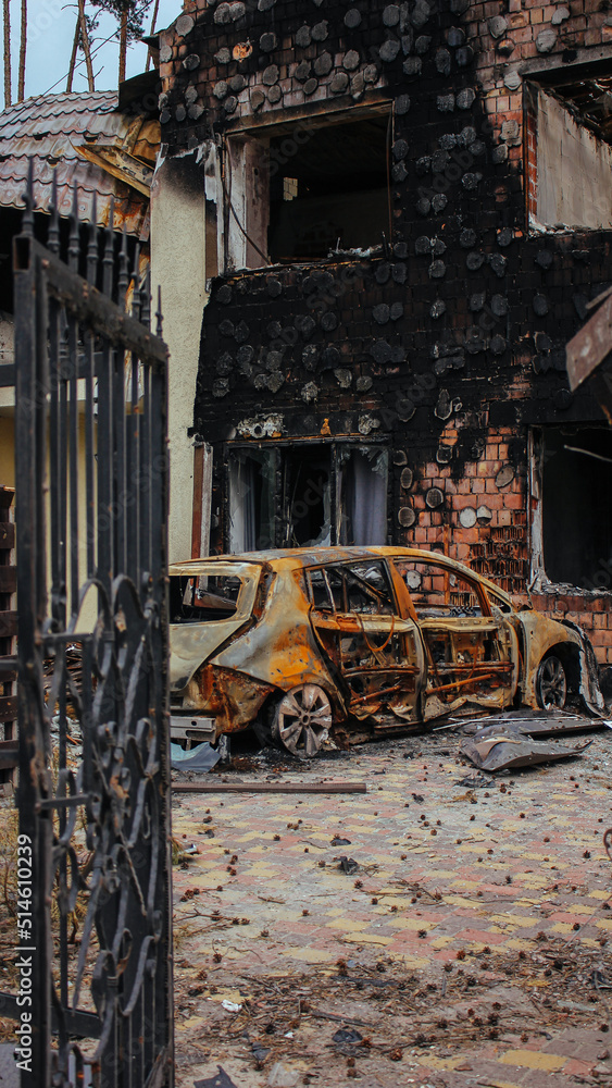 Irpin, Kyiv Oblast, Ukraine: Atrocities of the Russian army in the suburbs of Kyiv. Irpin. Destroyed car near house of civilians destroyed by russian tanks. Russia's war against Ukraine.