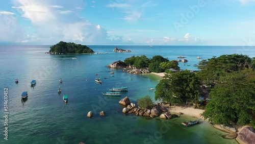 Belitung, Indonesia: Aerial drone footage of the stunning Kelayang beach and island with dramatic rocks in Belitung in the Java sea in Indonesia. Shot with a forward and rotation motion.  photo