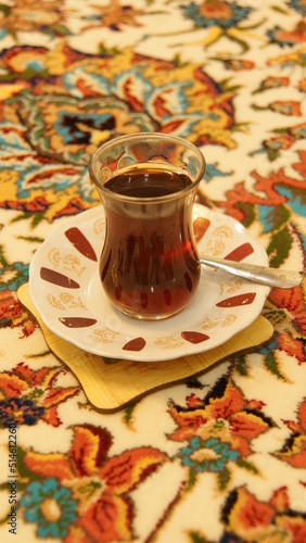 typically Arabian black tea served on a colorful floral carpet