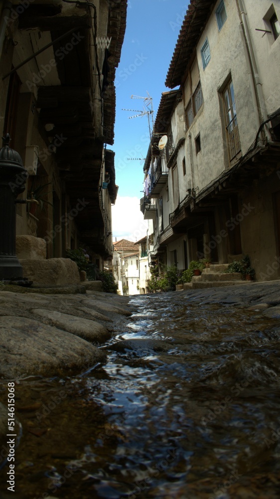 water running between the old houses of a pretty village