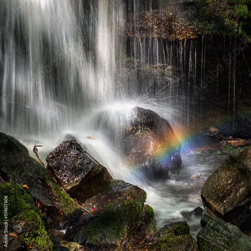 Fototapeta Naklejka Na Ścianę i Meble -  A small rainbow forming at the foot of a waterfall in the Campsie Fells