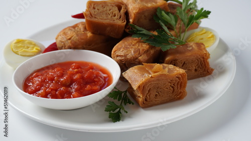 Jachnun or Jahnun, Yemenite Jewish pastry, served with fresh grated tomato and boiled egg and Zhug,  originating from the Adeni Jews, and traditionally served on Shabbat morning in Israel. photo