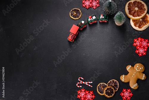 Delicious fresh chocolate biscuits on a dark concrete background with Christmas toys