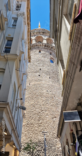 view of the galata towers from a small alley