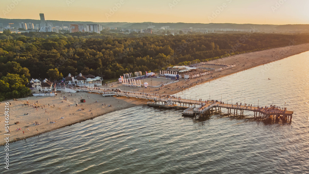 Obraz premium View of the beach and pier in Brzeźno, Gdańsk at sunset. Summer 2022.