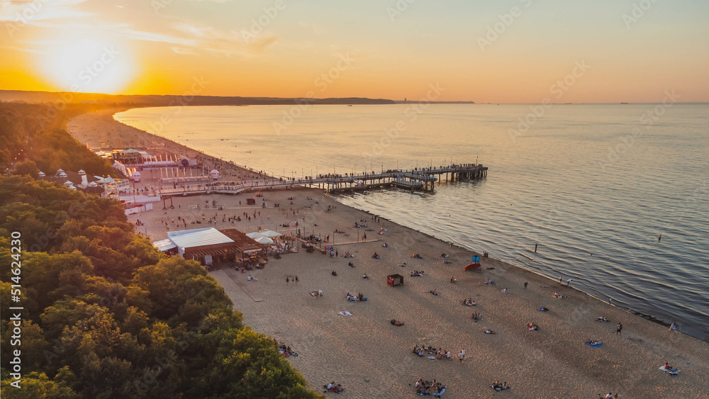 Fototapeta premium View of the beach and pier in Brzeźno, Gdańsk at sunset. Summer 2022.