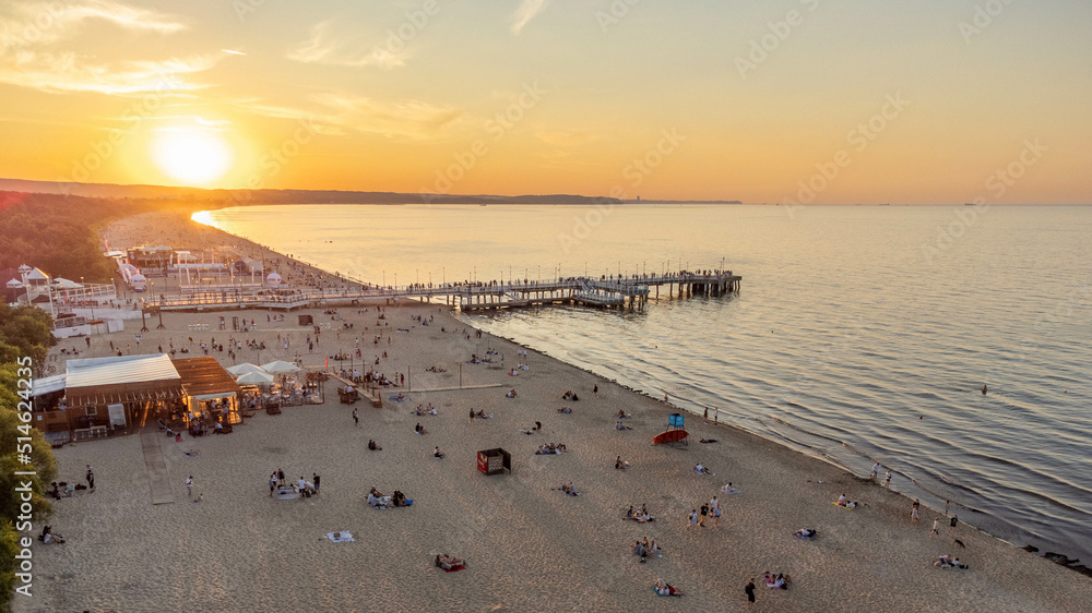 View of the beach and pier in Brzeźno, Gdańsk at sunset. Summer 2022.
