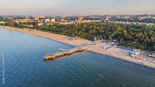 View of the beach and pier in Brzeźno, Gdańsk at sunset. Summer 2022.