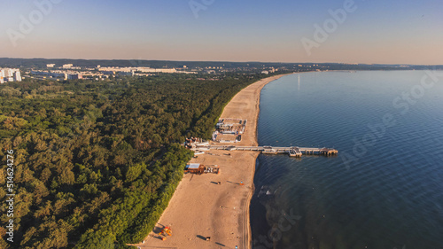 View of the beach and pier in Brzeźno, Gdańsk at sunrise. Summer 2022.